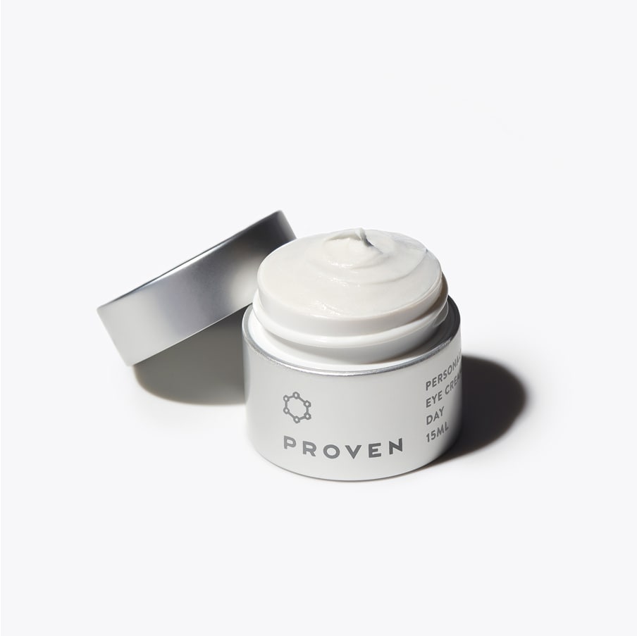 The same jar open with its cap resting beside it, showing the white cream inside.