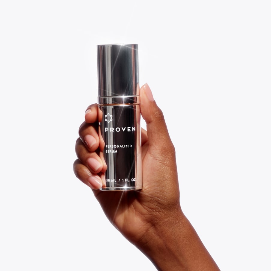A hand holding the Personalized Serum bottle.