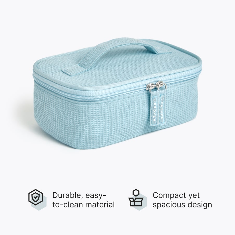 The light-blue textured toiletry bag with a top handle and zip, above two claims: durable easy-to-clean material, compact yet spacious design.