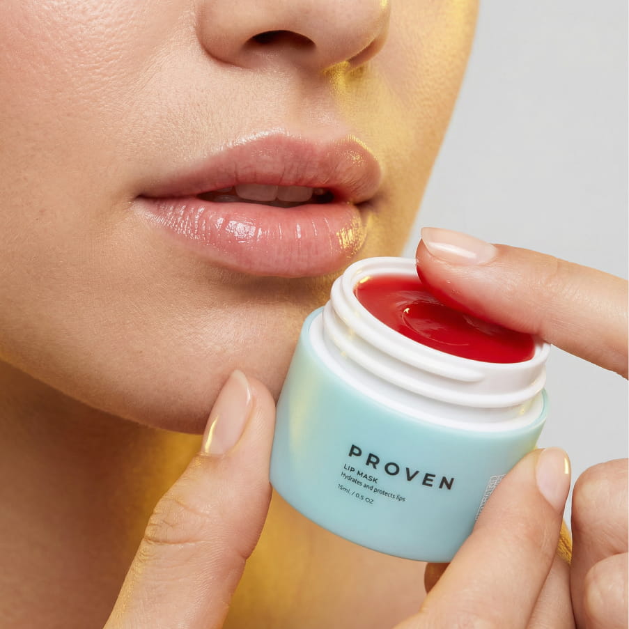 A woman holding the open jar beside her lips
