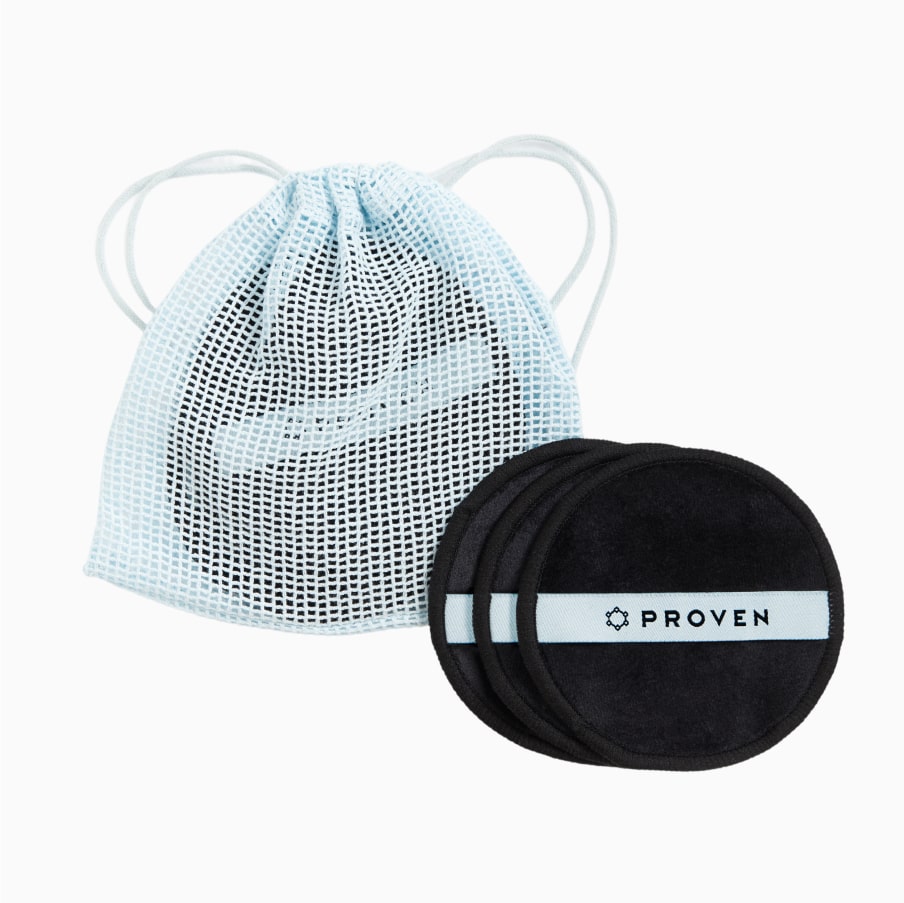 The light-blue drawstring mesh wash bag beside a stack of the black rounds.