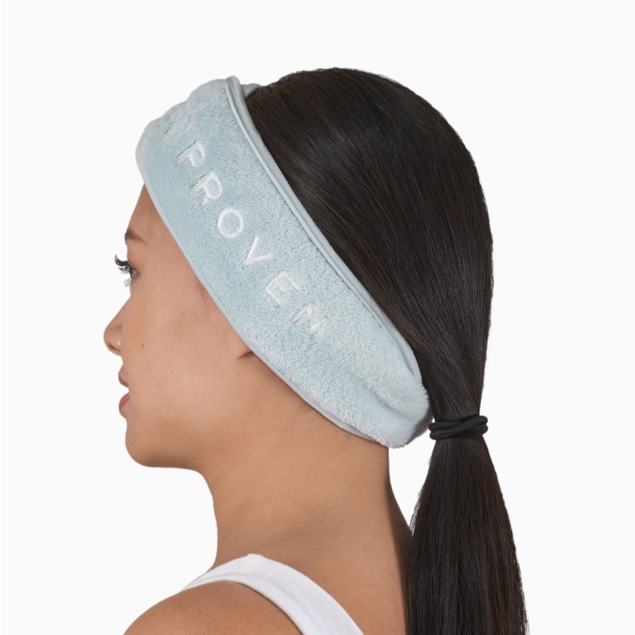 A person wearing the headband at the hairline with their hair tied back, seen in profile.