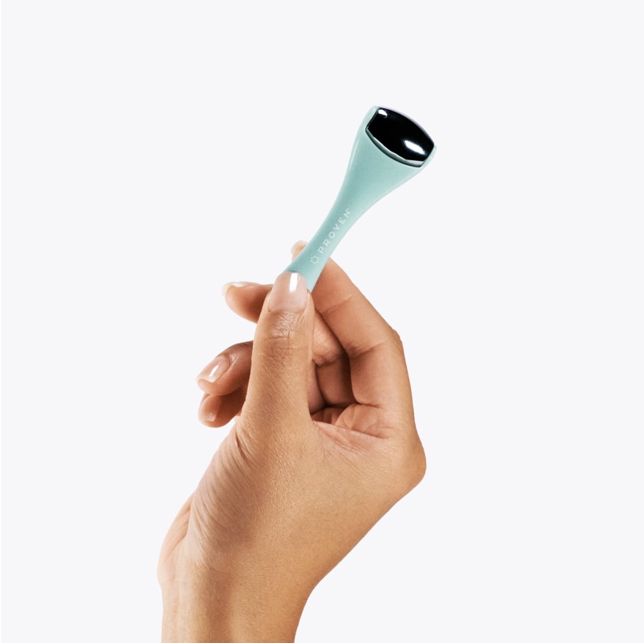 A hand holding the roller between two fingers, showing how small it is.