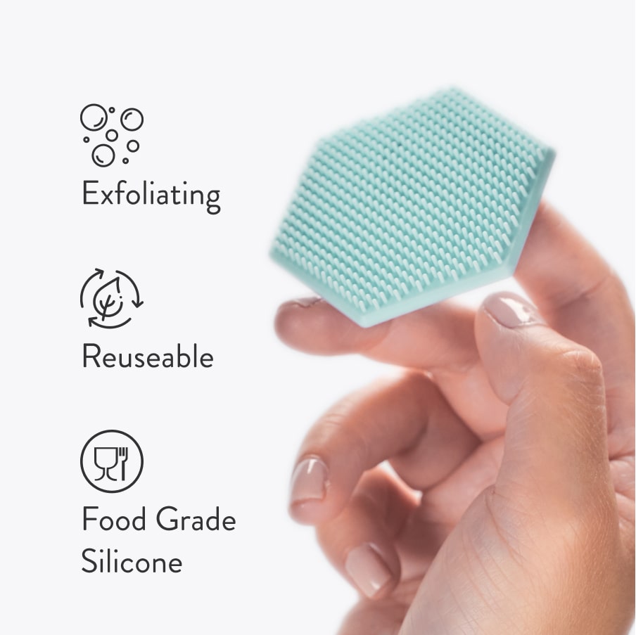 A hand holding the mint green hexagonal silicone pad, beside three benefits: exfoliating, reusable, and food grade silicone