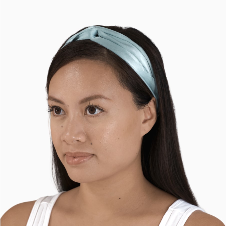 A person wearing the silk headband, showing how it sits back from the face.