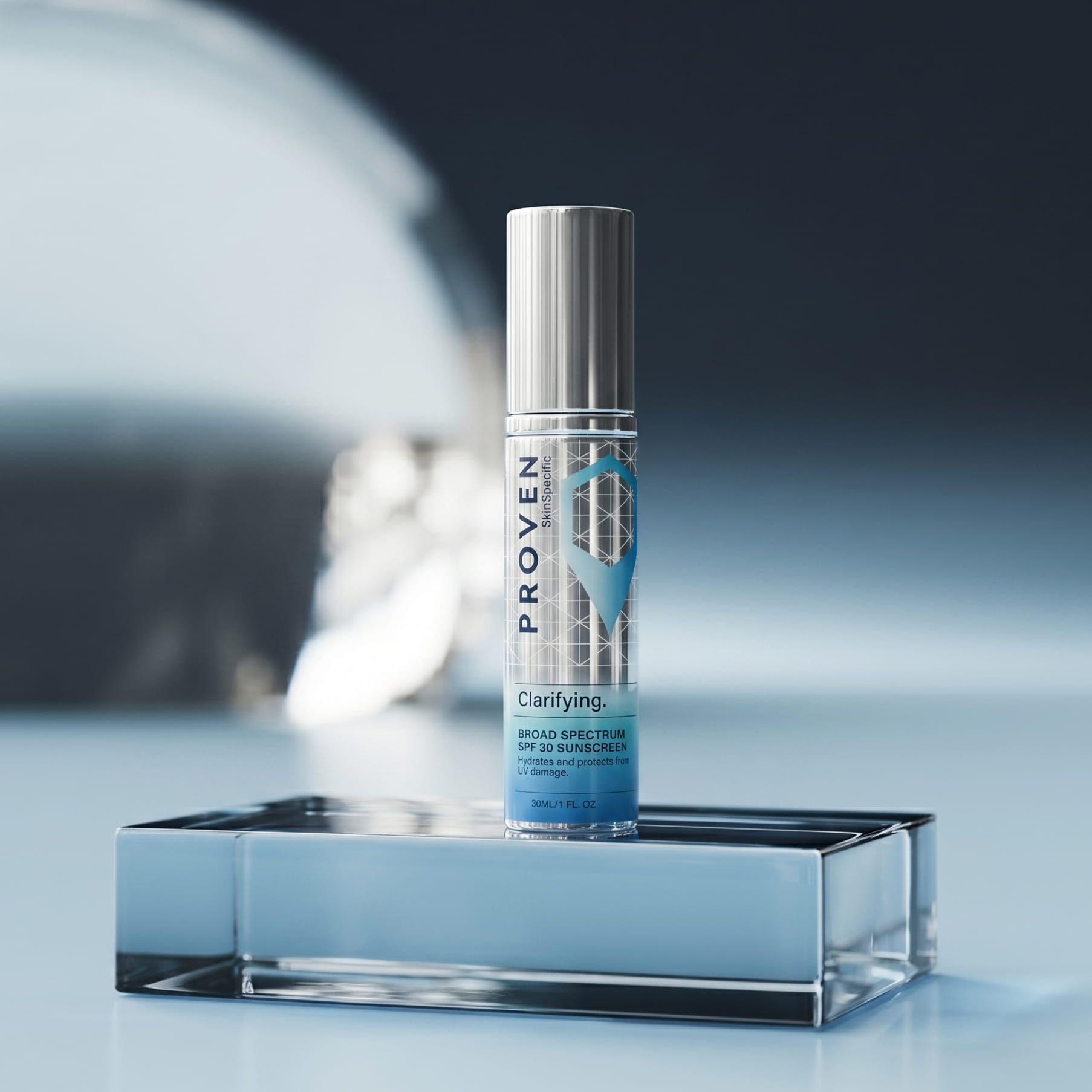 The SkinSpecific Clarifying Broad Spectrum SPF 30 Sunscreen bottle, silver with a blue label, on a blue glass block