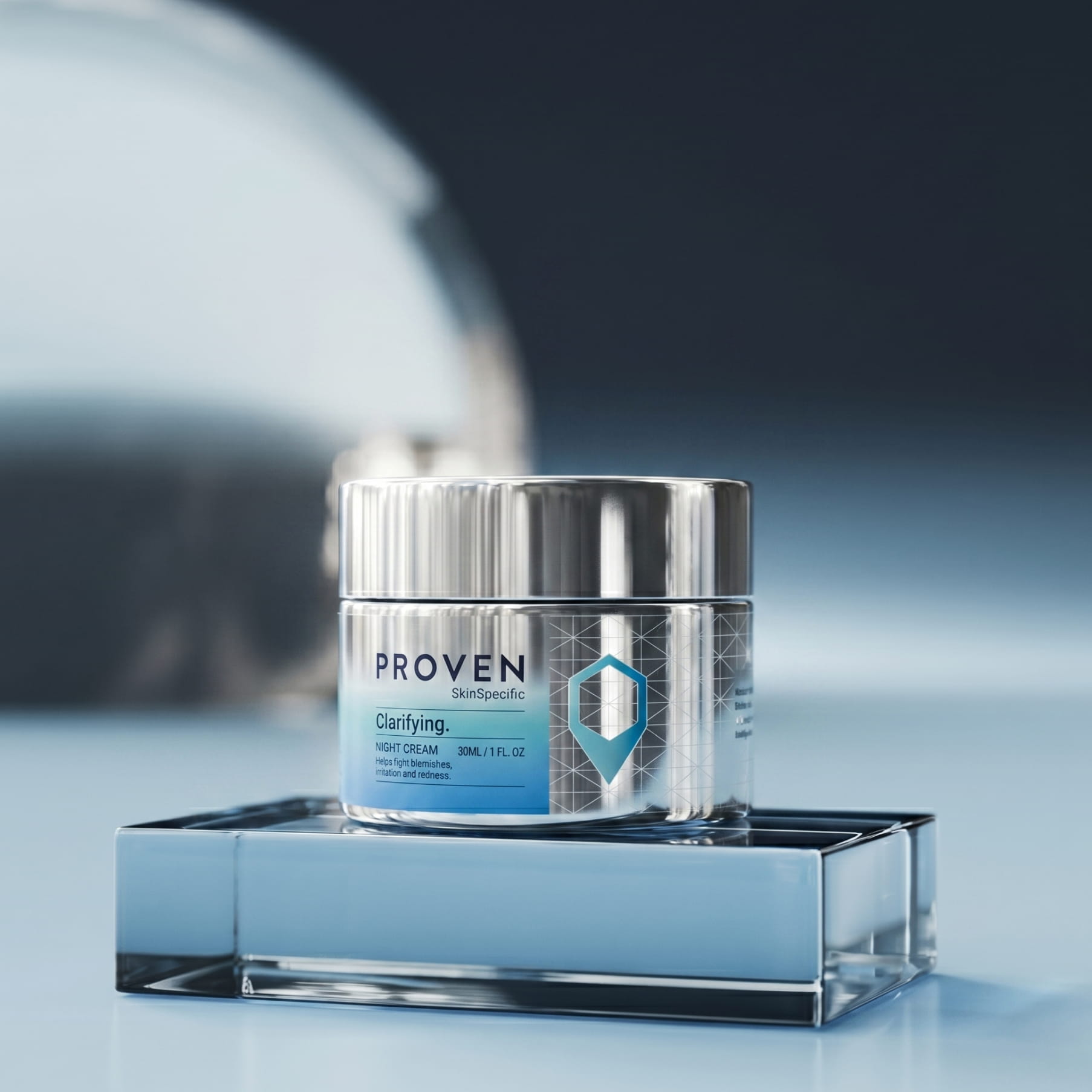 The SkinSpecific Clarifying Night Cream jar, silver with a blue label, on a blue glass block